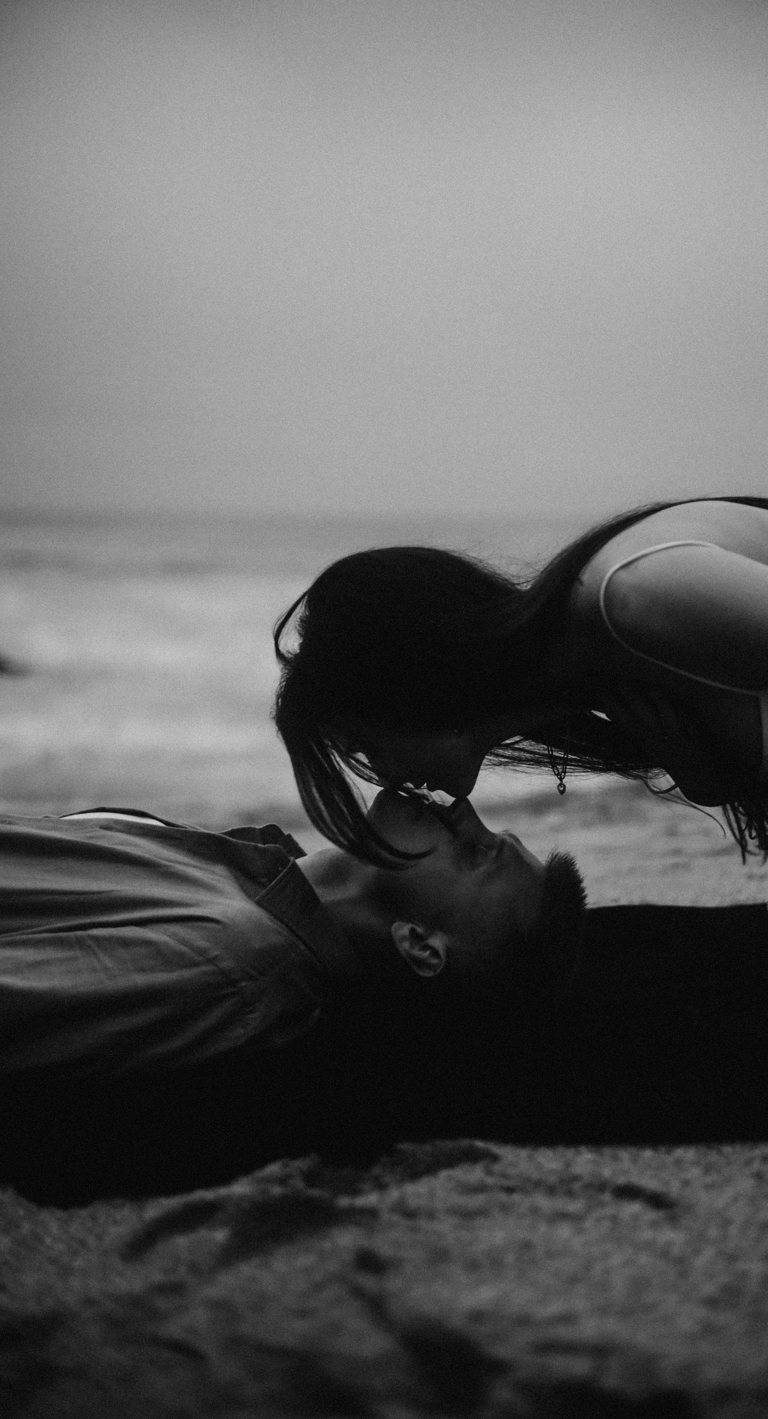 Love story on the beach in California with emotional, candid moments