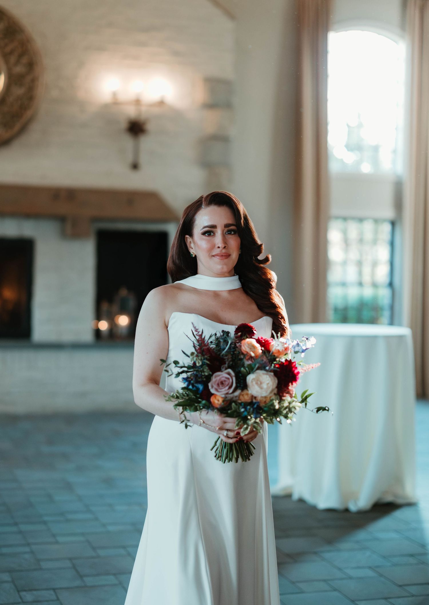 A series of wedding photos showing a white bridal gown and pink and burgundy floral bouquet in an elegant indoor venue.