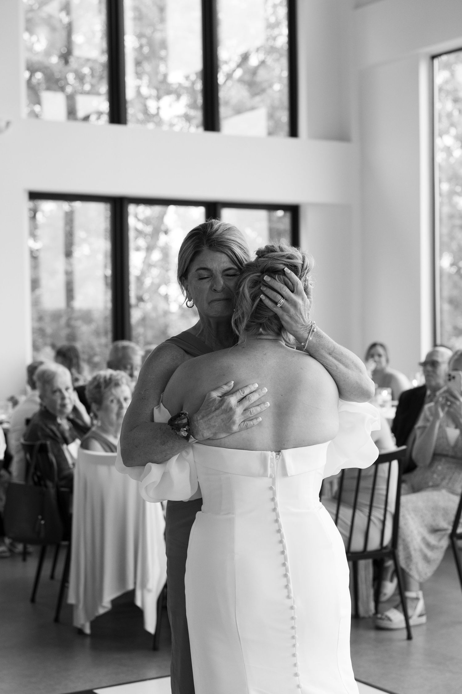 Intimate dance moment captured in black and white at an elegant wedding reception.