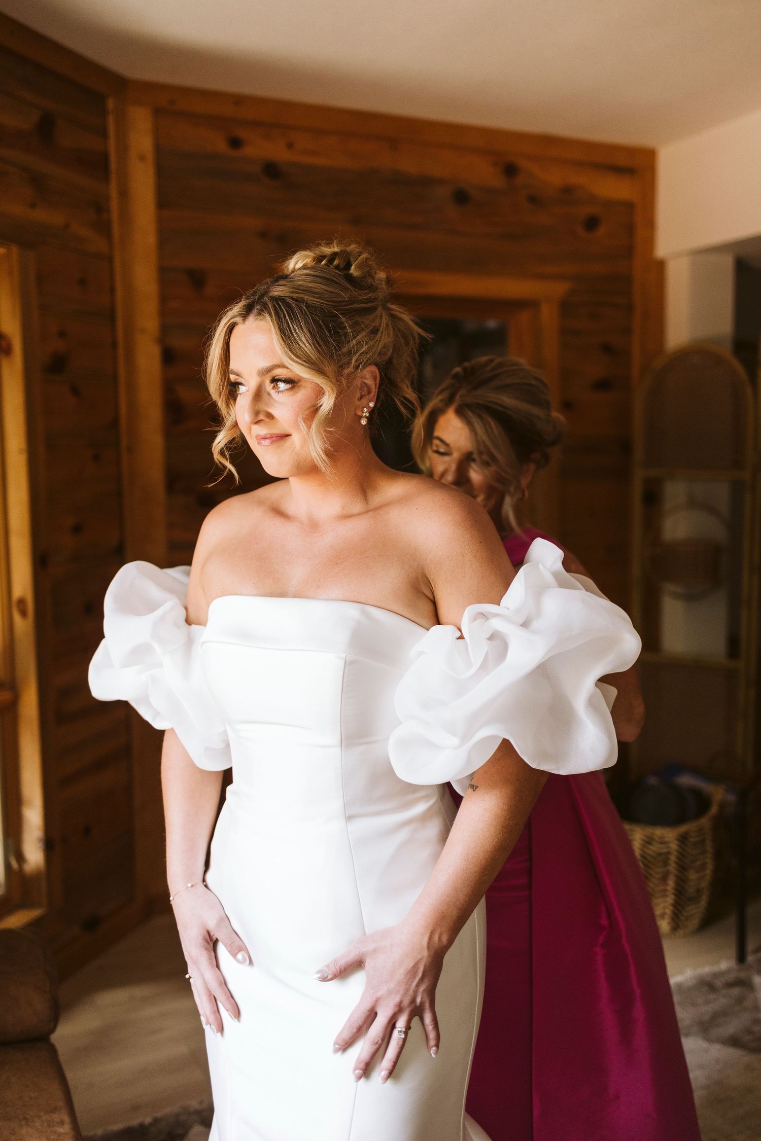 Stylish white wedding gown with dramatic puff sleeves and elegant silhouette being prepared for the big day.