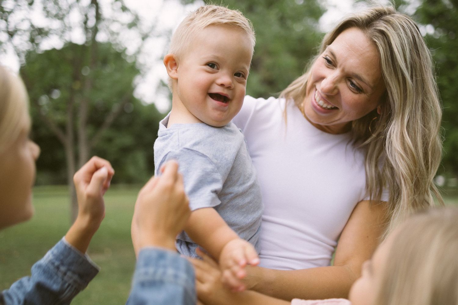 Candid outdoor family moment with laughter and joy.