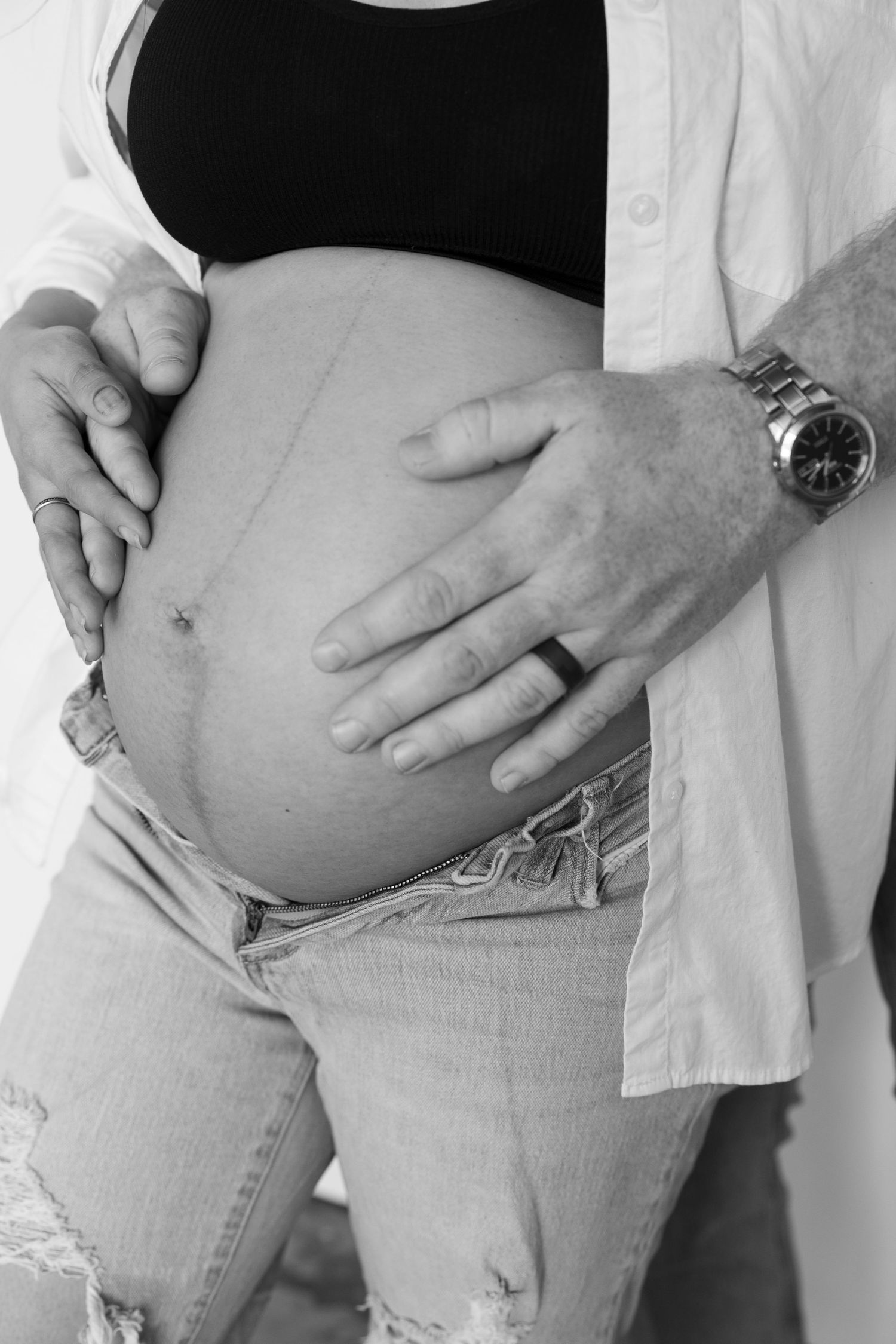 Black and white progression photos showing growing baby bump during pregnancy.