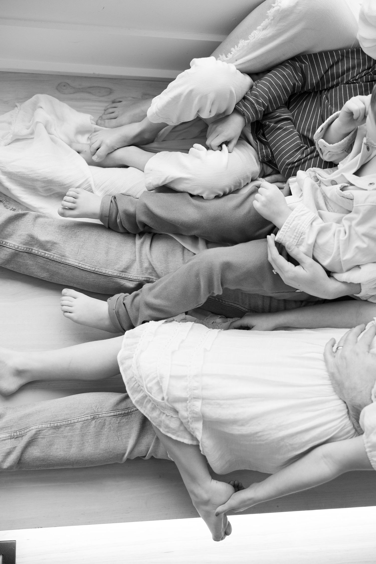 Black and white image of legs and feet resting together in casual comfort.