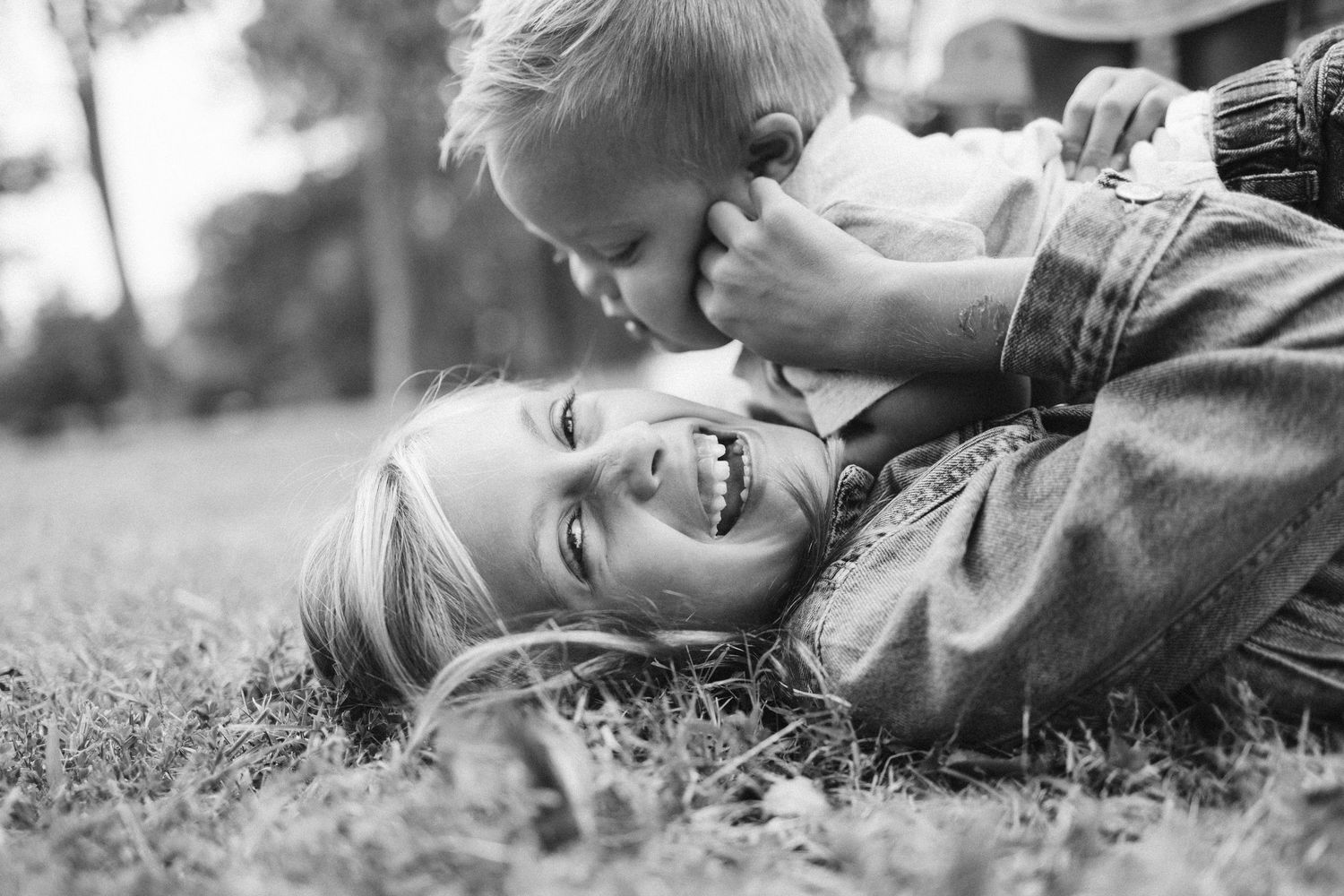Black and white portrait of playful moments on the grass.