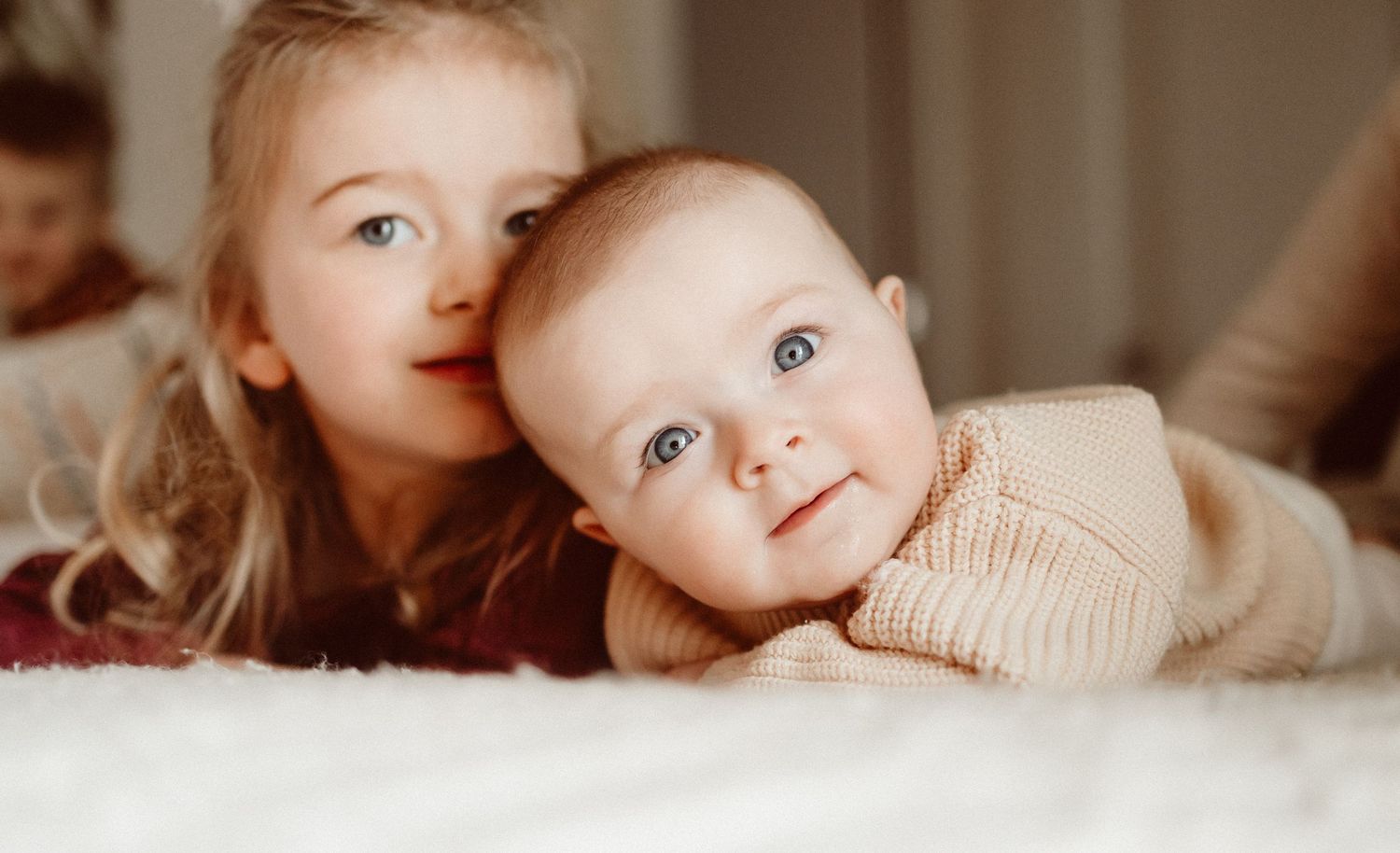 Close-up portraits showing sweet baby expressions and interactions.