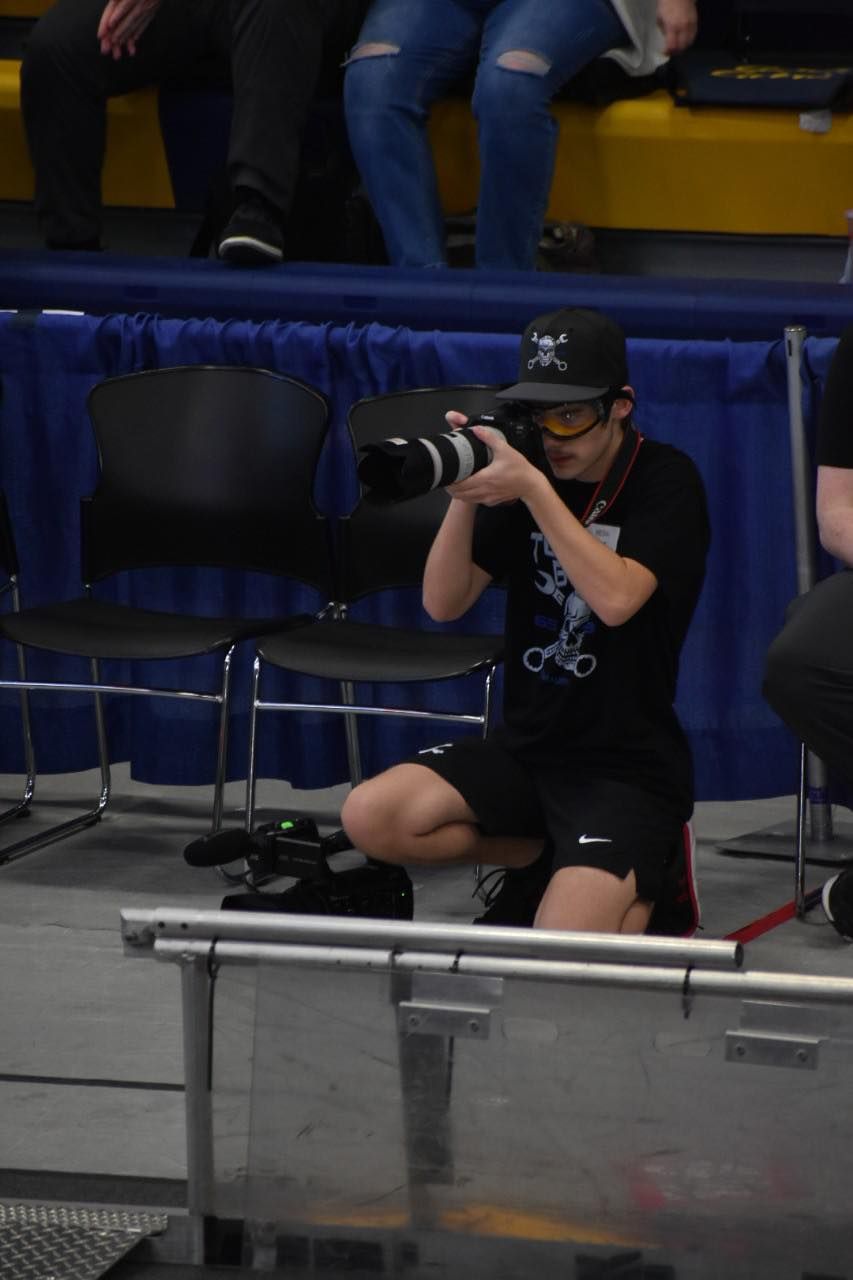 Wyatt Szucs Taking Pictures During Robotics Competition