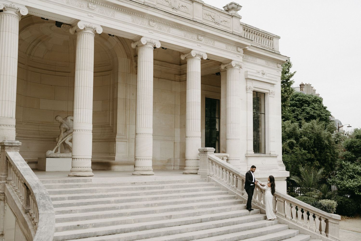 Editorial wedding couple on the steps of Palais Galliera in Paris, elegant destination photography by Studio Reverie.