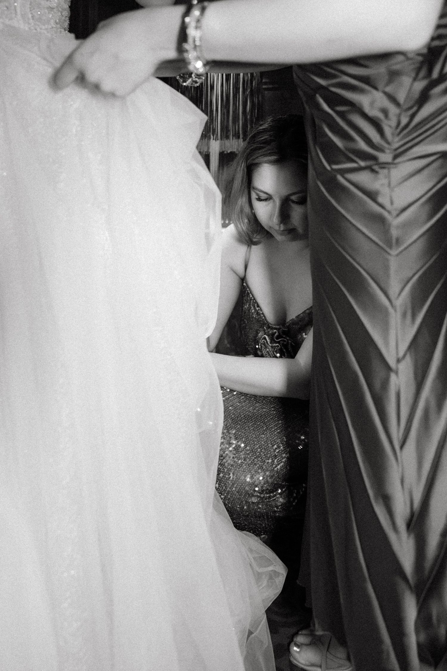 Black and white detail shot of formal dresses with sparkly embellishments.