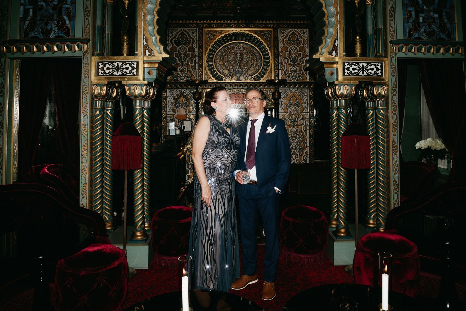 Ornate gothic church interior with dramatic lighting and architectural details during an evening ceremony.