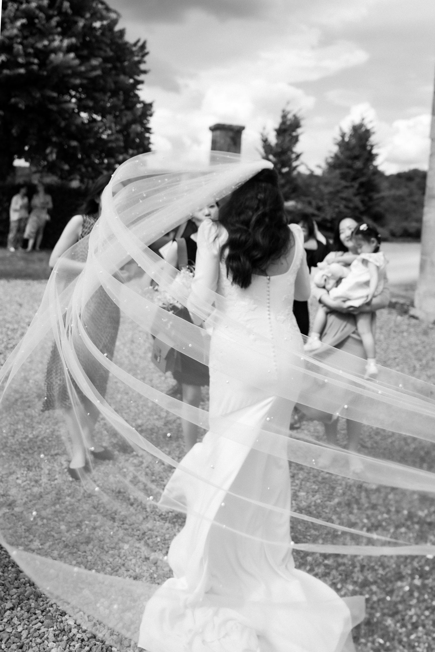 Black and white sequence of a bride's veil flowing dramatically in the wind.