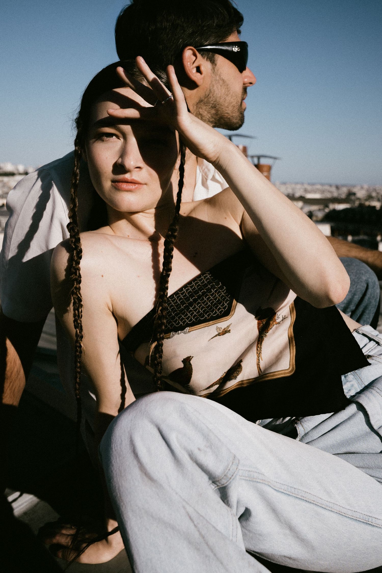 A series of intimate black and white photographs showing a couple relaxing together in sunlight.