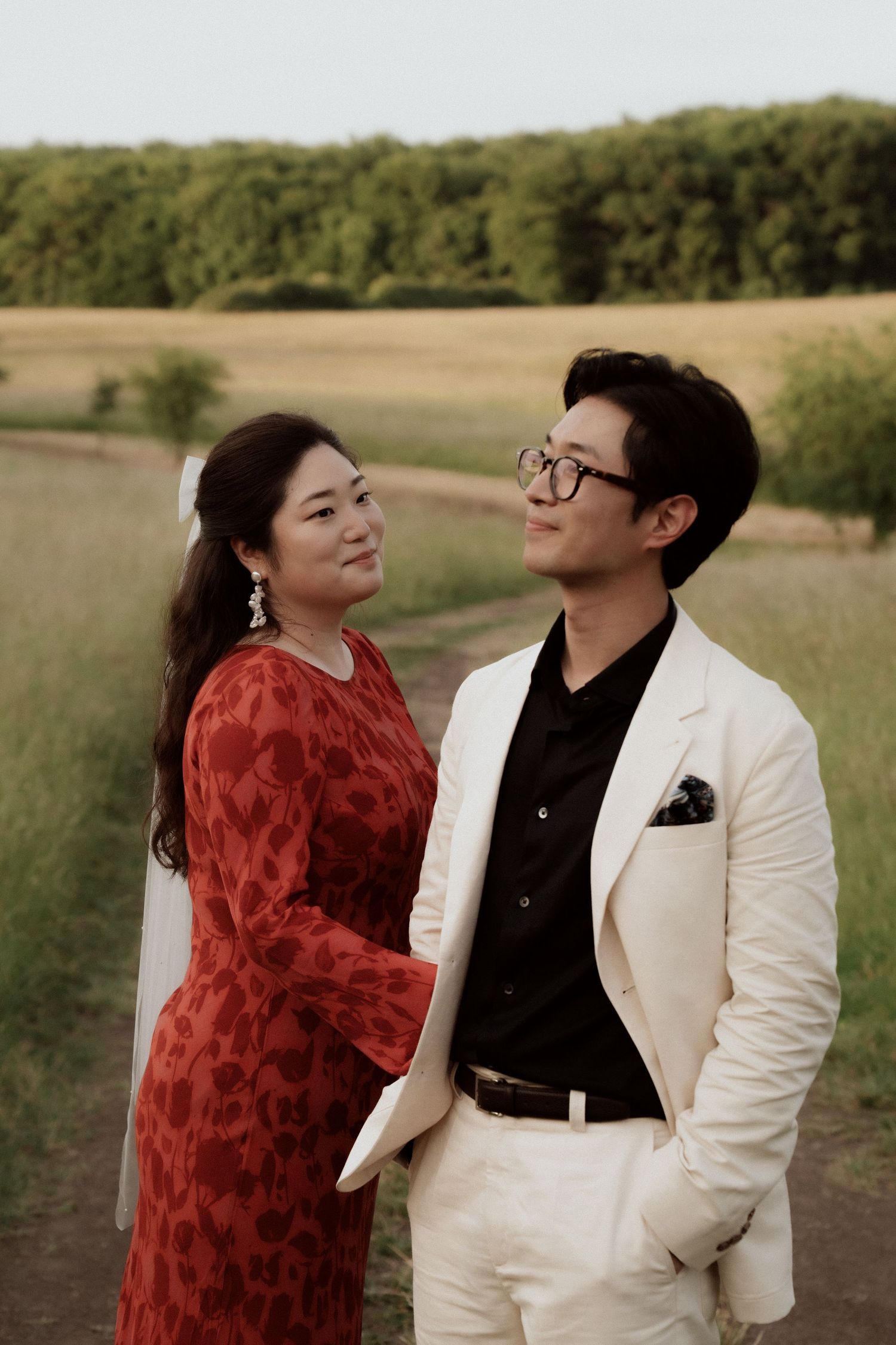 Romantic outdoor photo sequence in a natural field setting at golden hour.