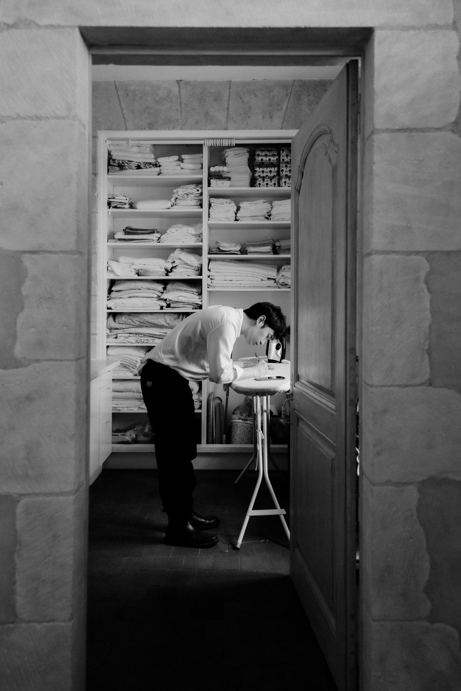 Black and white photo series showing a dark room with filing cabinets and shelving in dramatic lighting.