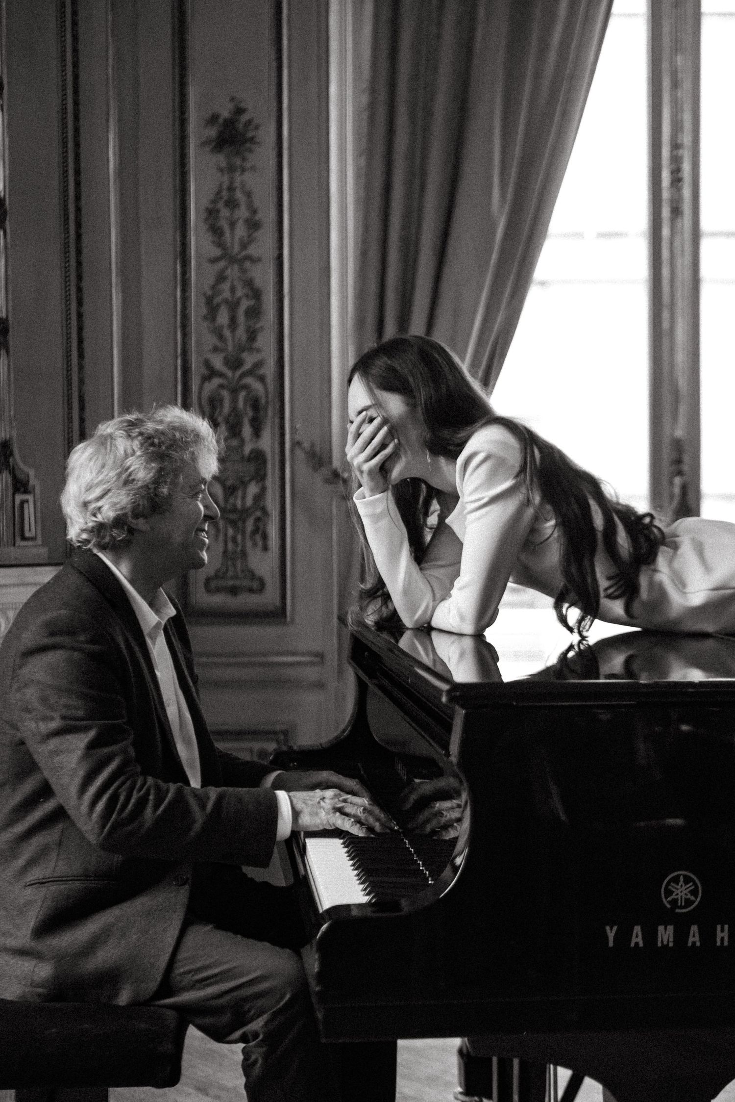 Intimate artistic portrait of couple by piano in Paris, romantic and editorial black and white photography
