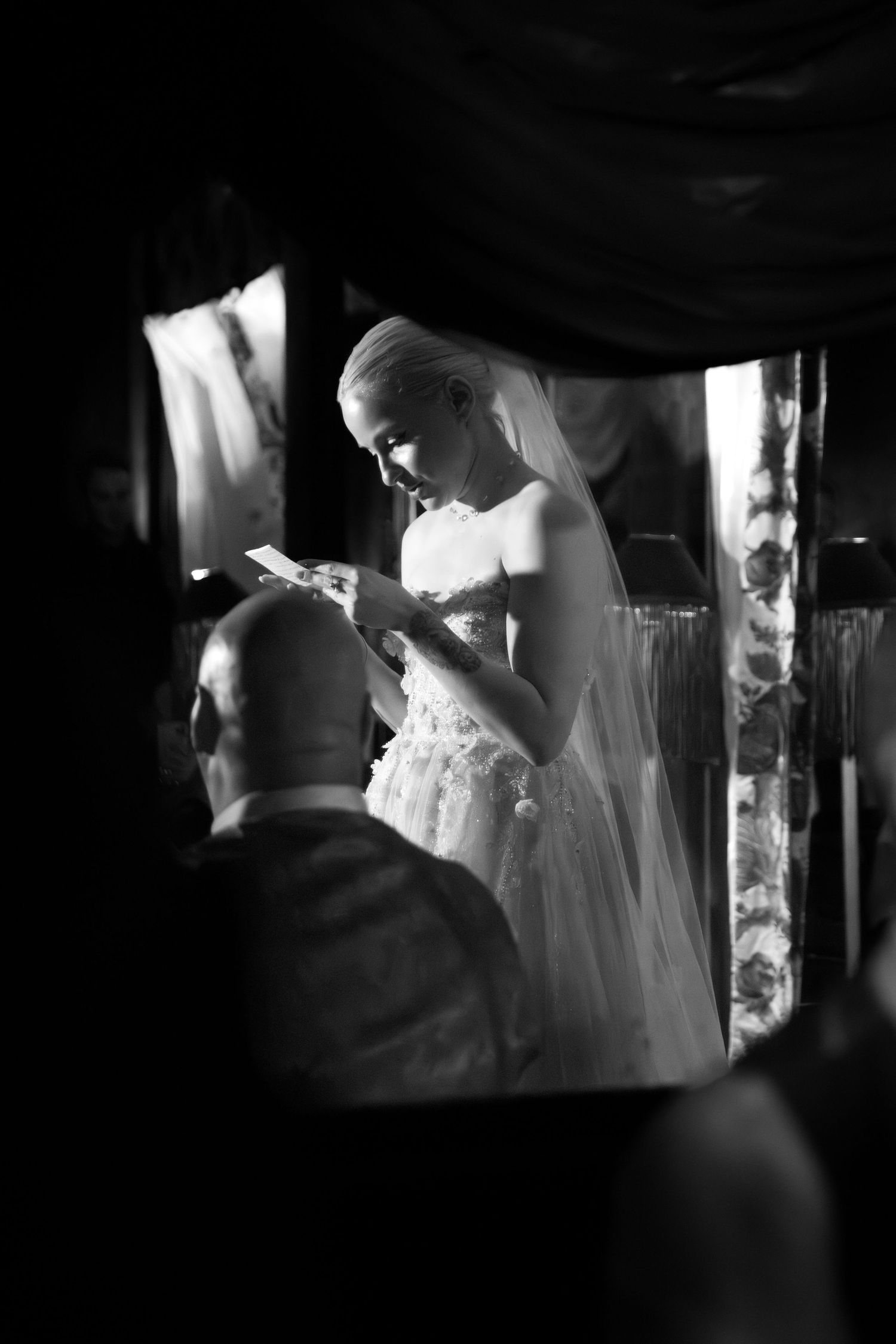 Artistic black and white wedding photography with dramatic shadows and lighting.