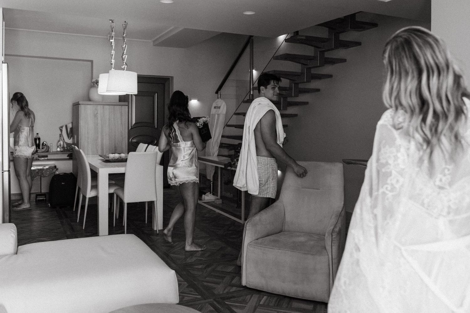 A black and white photo showing a staircase and interior hallway of a modern building.