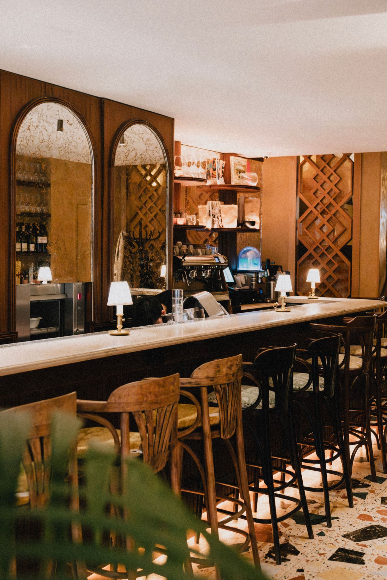 Vintage bar interior with wooden stools and warm lighting showcases classic design elements and cozy ambiance.