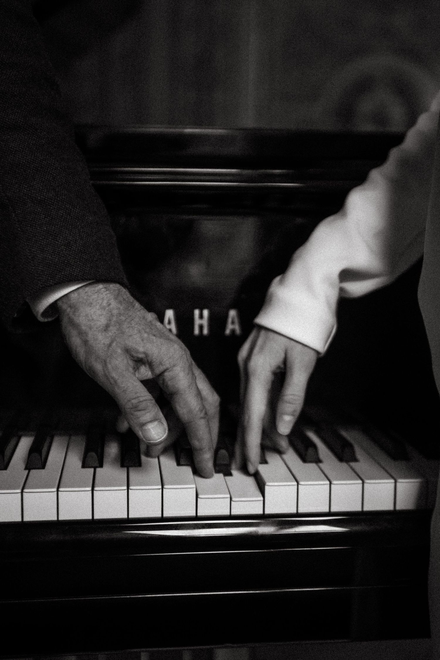 Cinematic editorial portrait in Paris of hands playing a Yamaha piano, artistic and romantic atmosphere