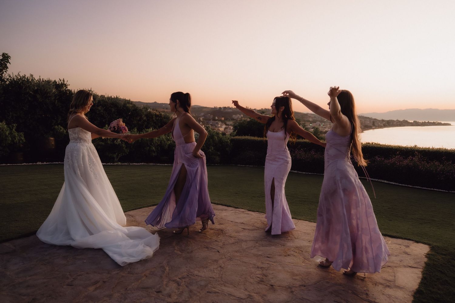 A sequence of wedding party photos at sunset shows people dancing and celebrating on a scenic coastal overlook.