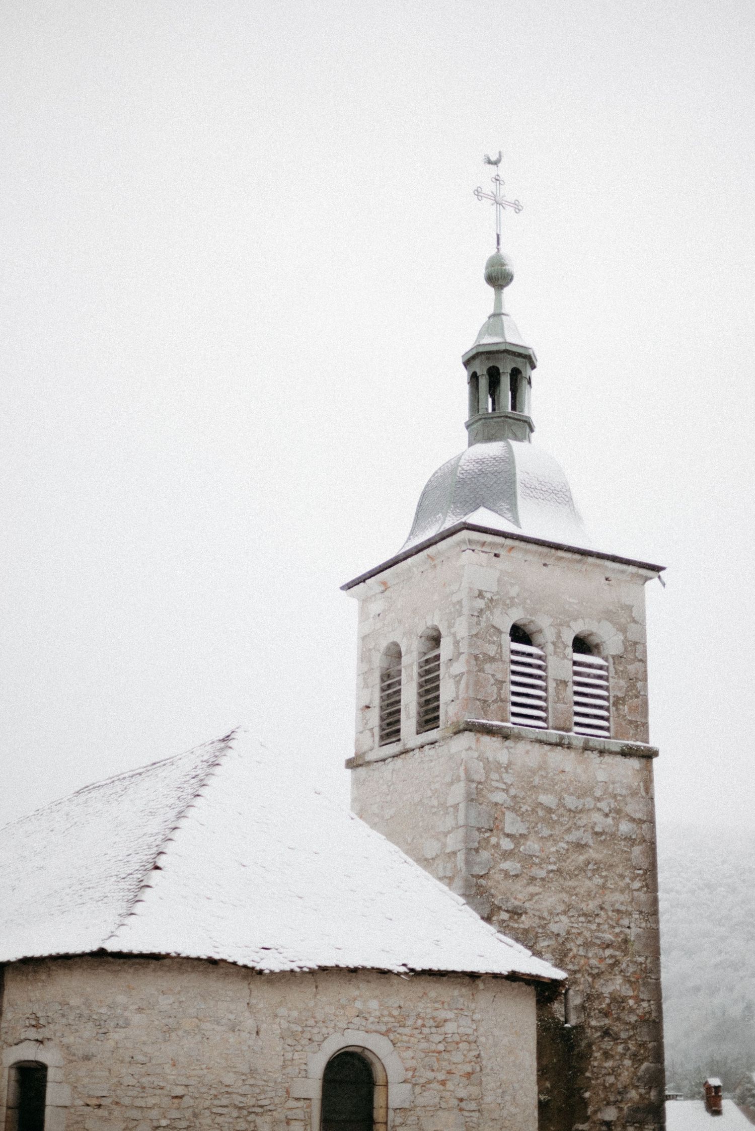 Snowy village church in the French Alps captured for travel and content storytelling with a cinematic, calm tone.