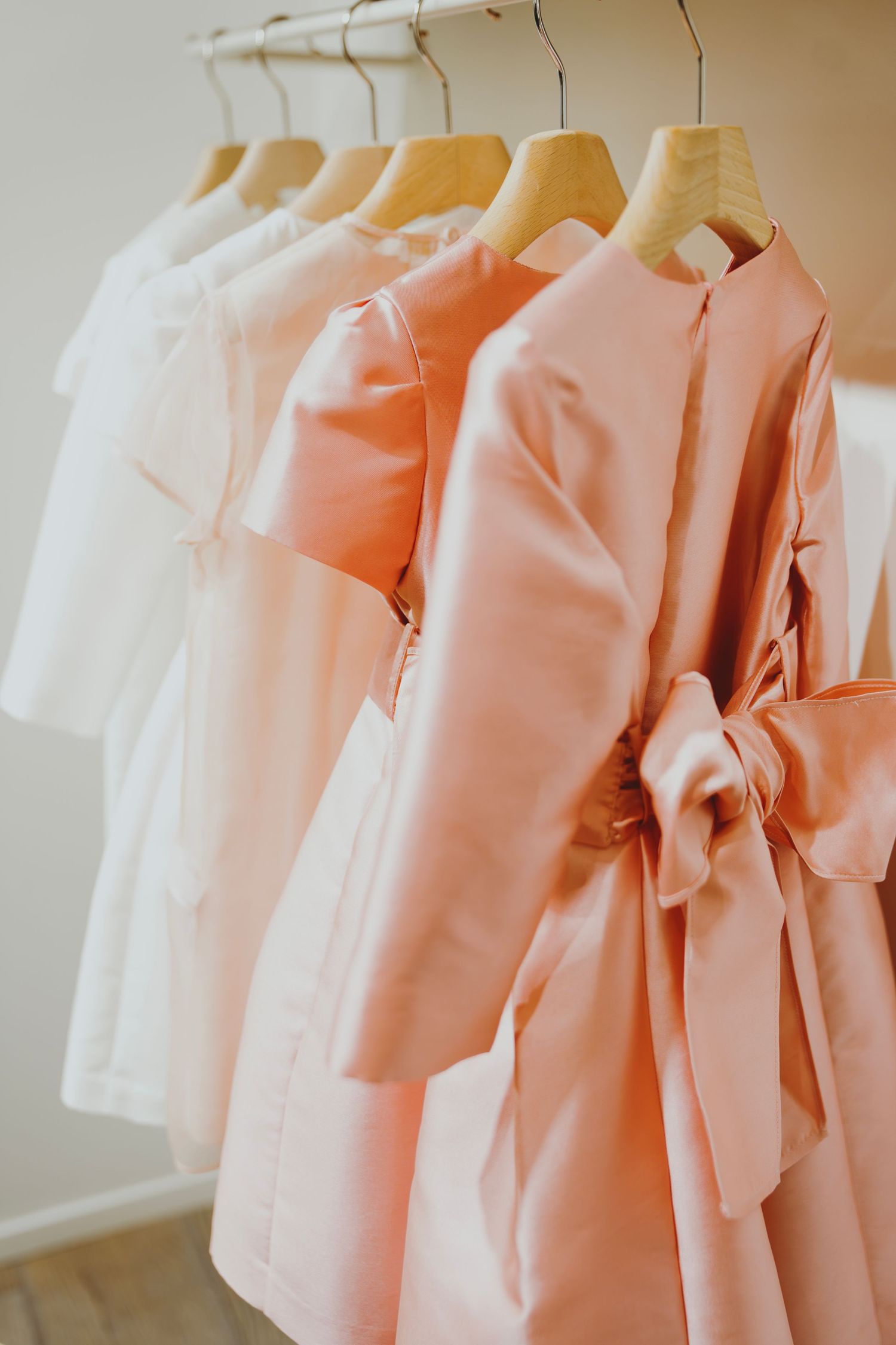 Editorial event photography at Il Gufo in Paris, pastel kids dresses on display in soft light, cinematic and elegant visual storytelling.