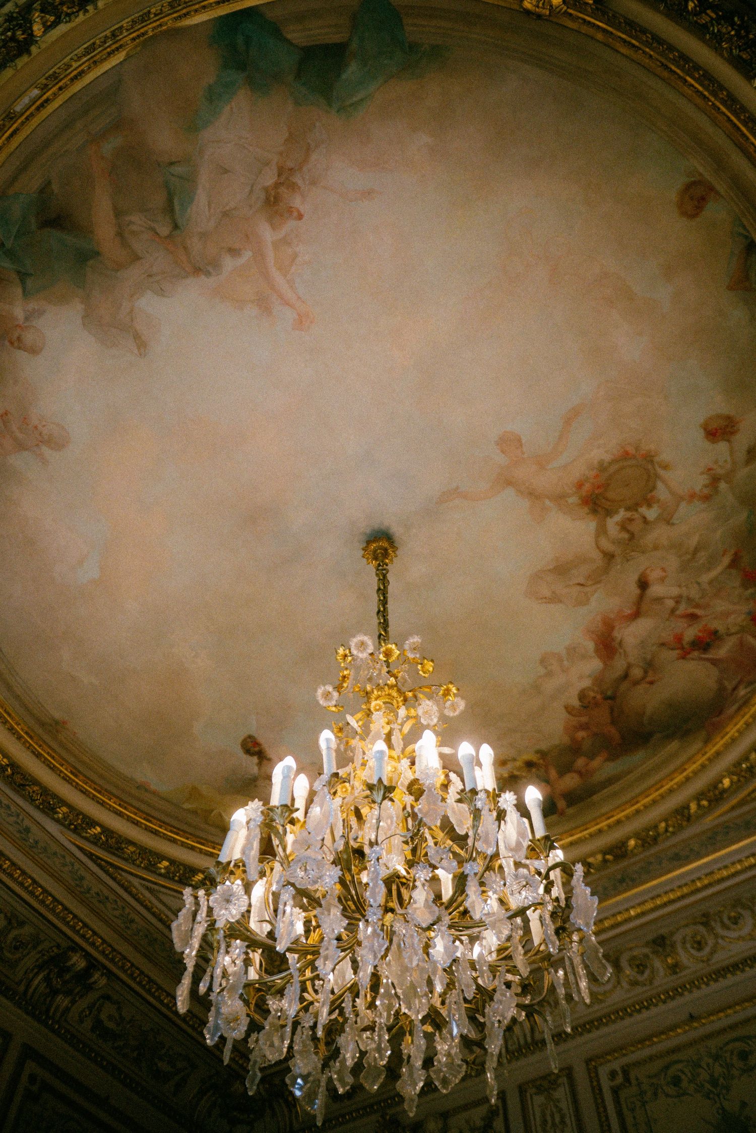 Paris wedding detail of antique chandelier and fresco ceiling, romantic editorial wedding photography in Europe