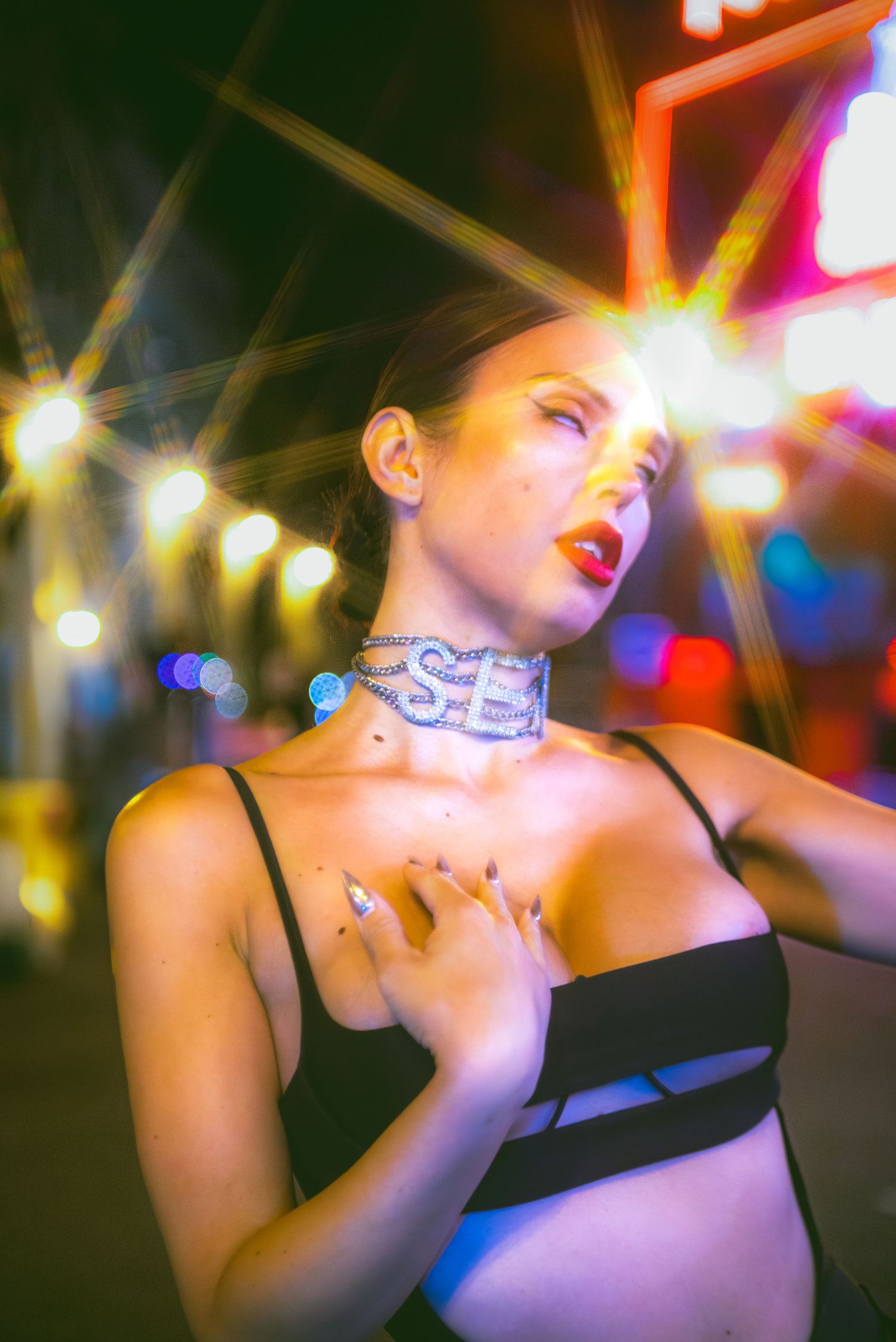 Artistic nighttime portrait with colorful bokeh lights and glowing effects creating a dreamy atmosphere.