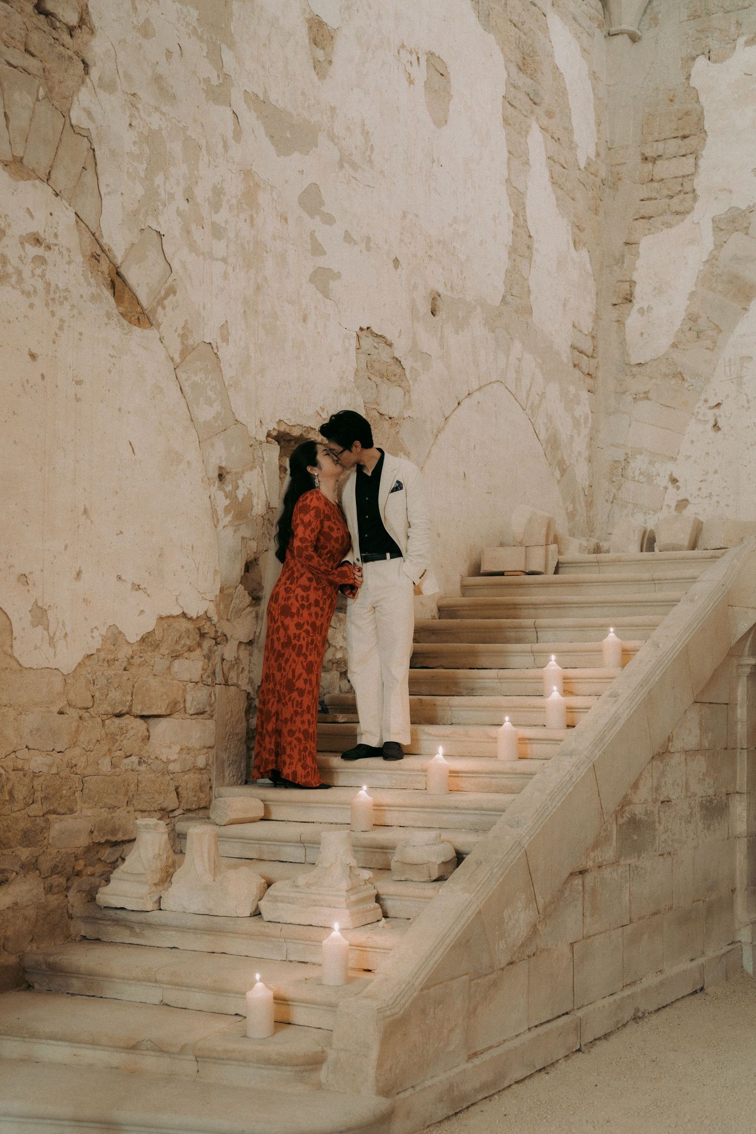 Romantic stone staircase decorated with glowing candles creates an atmospheric setting.