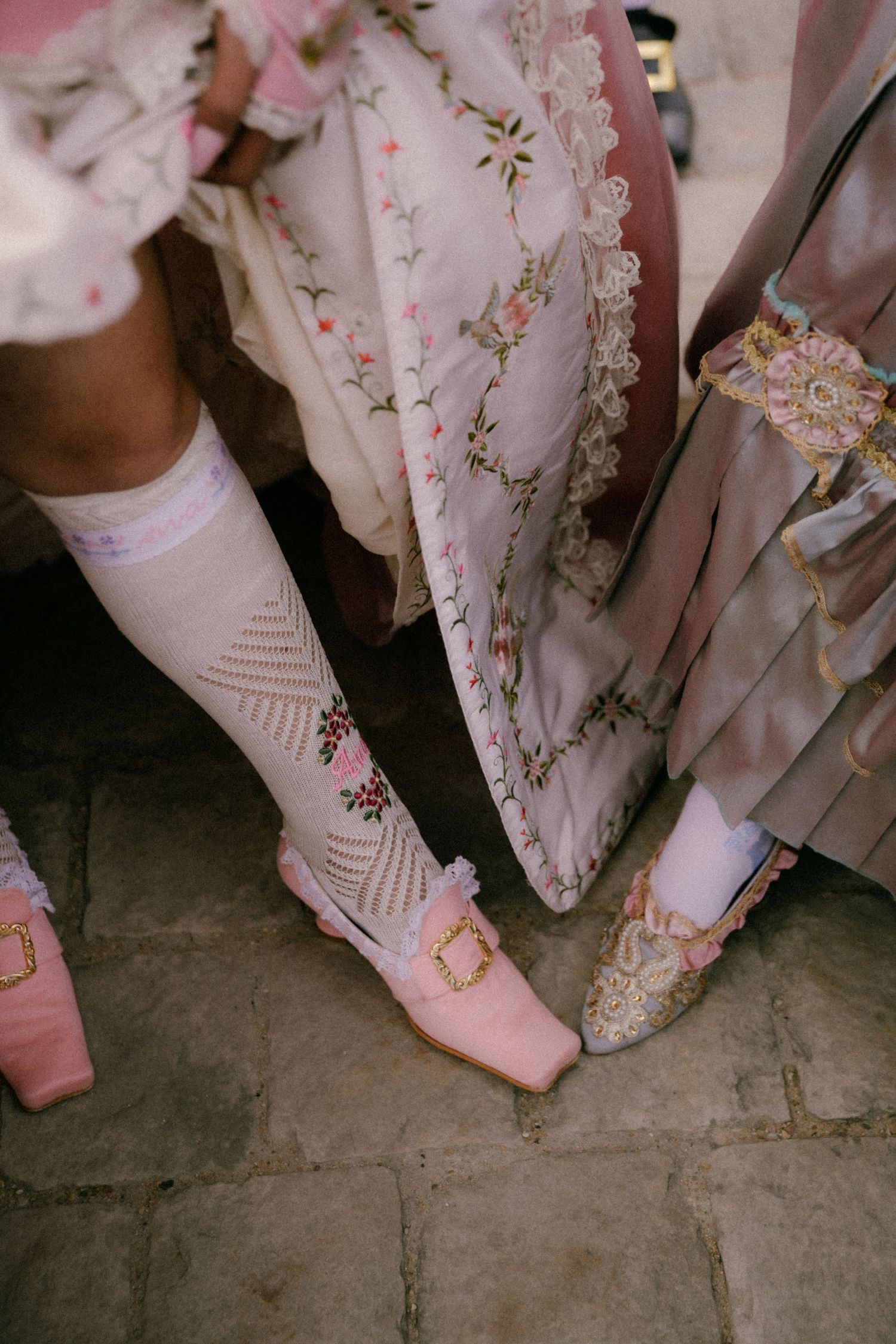 Rococo shoes, high socks, and ball gowns create an elegant scene of Versailles.