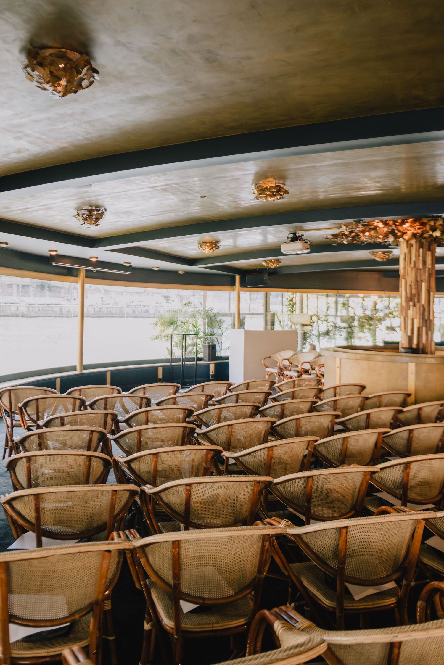 Elegant Paris event venue with vintage chairs and warm light, editorial-style storytelling atmosphere at Pont Neuf on the Seine river.