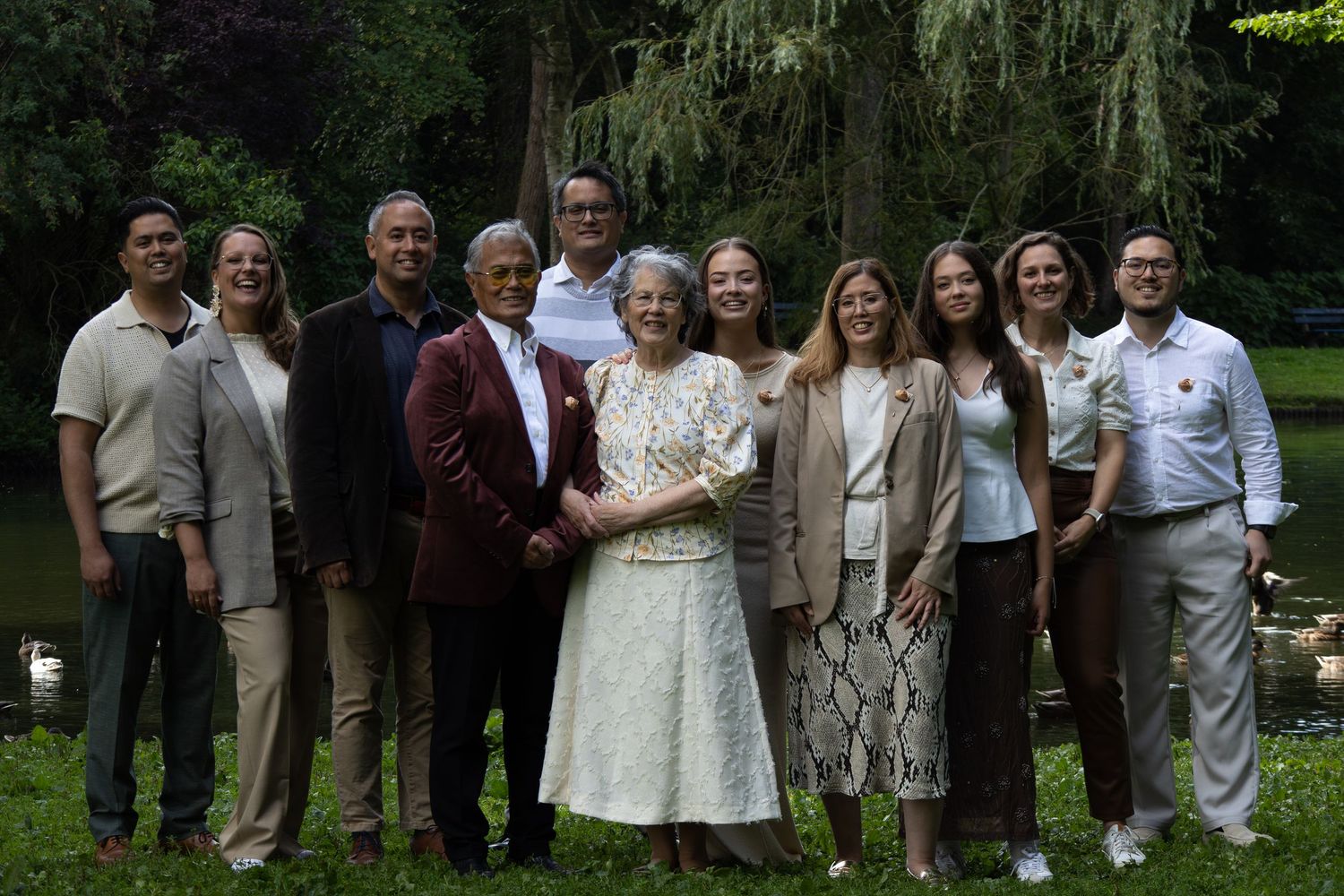 A collection of candid outdoor wedding photos showing guests and wedding party members posing in a garden setting.