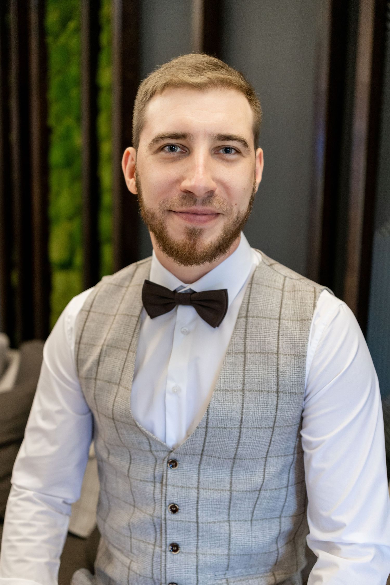 Classic windowpane waistcoat and bow tie outfit displayed in professional photoshoot.