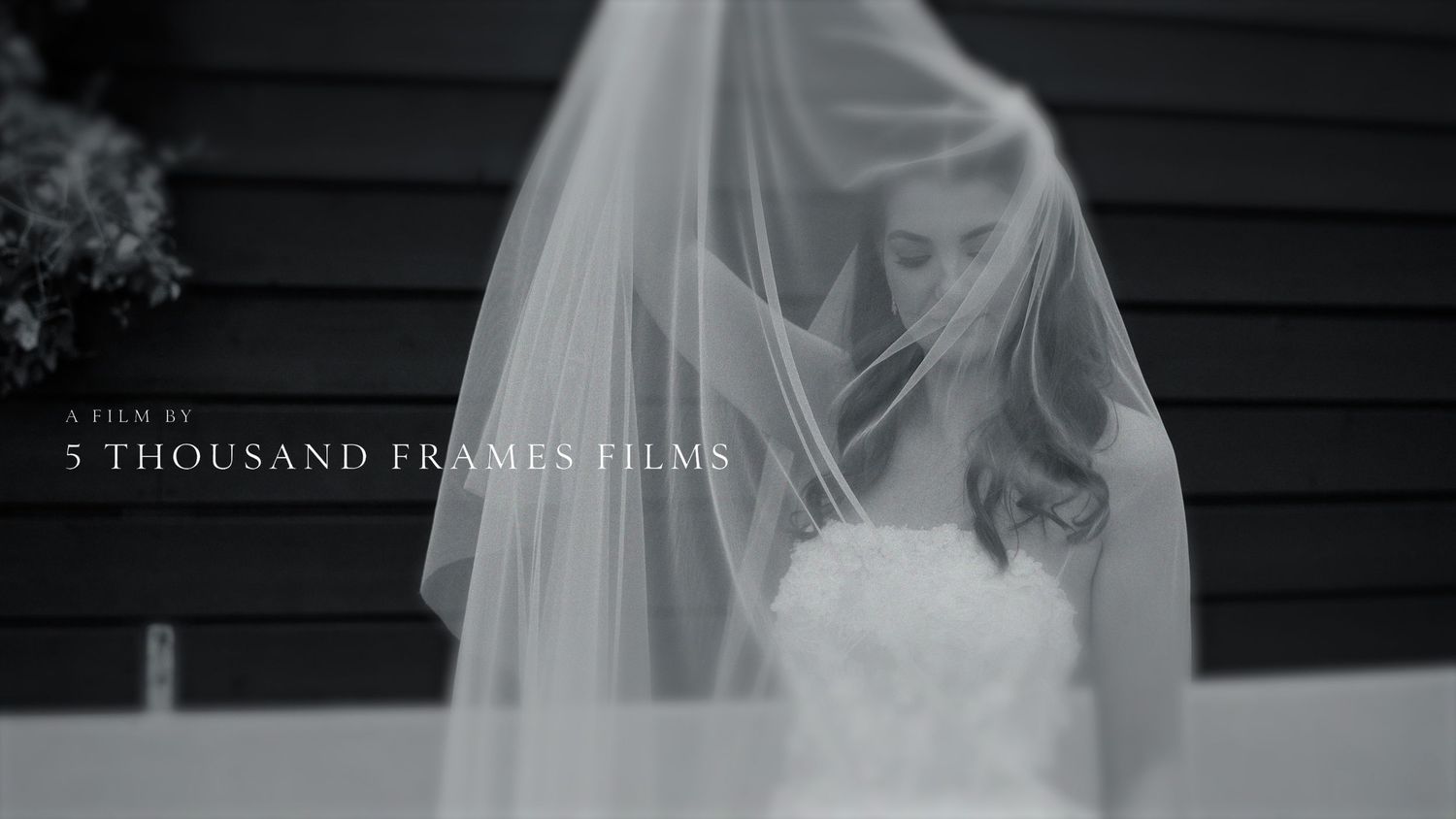Bride in white wedding dress and veil by 5 Thousand Frames Films, elegant black and white wedding cinematography.