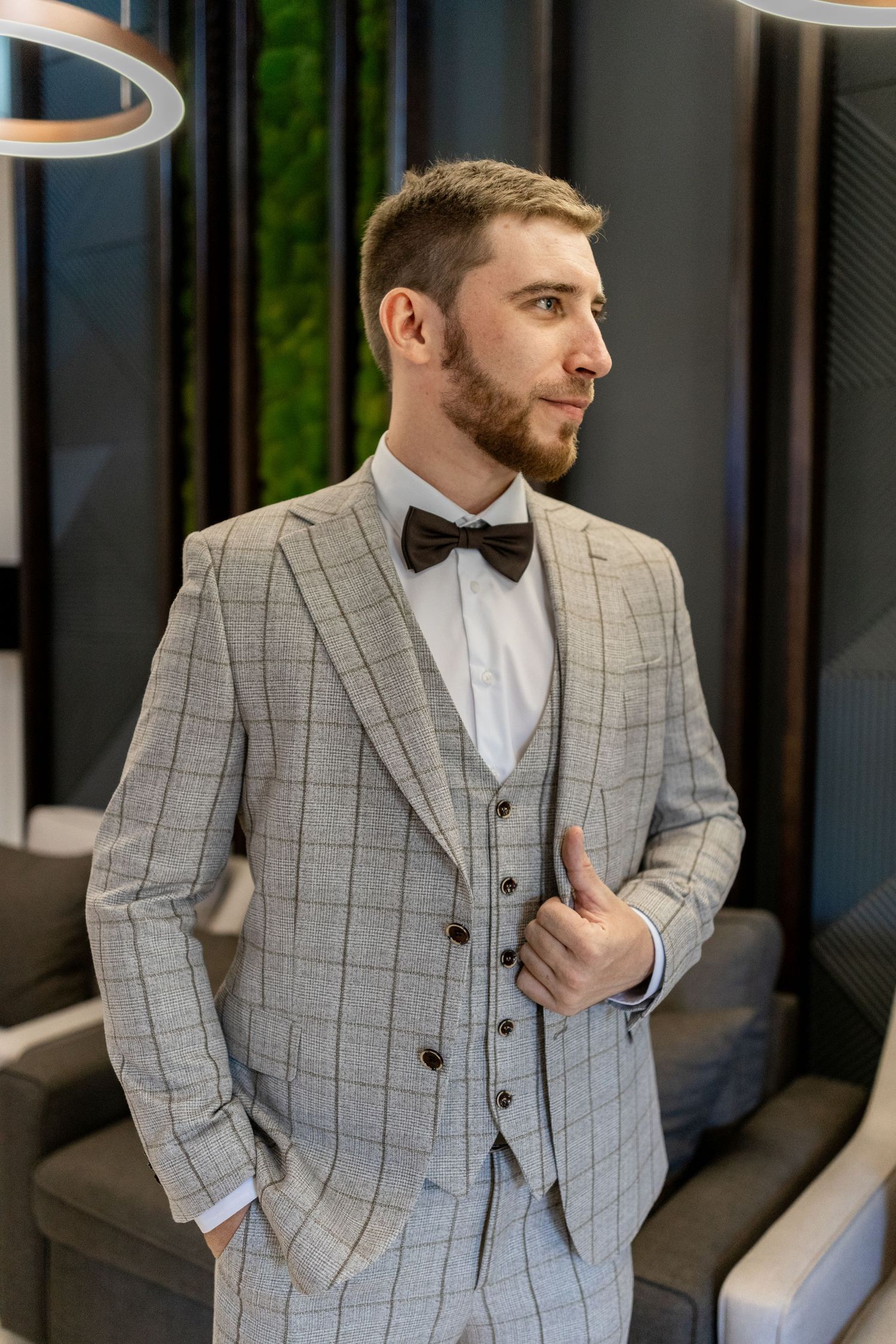 Professional fashion shots of light gray windowpane suit against modern backdrop.