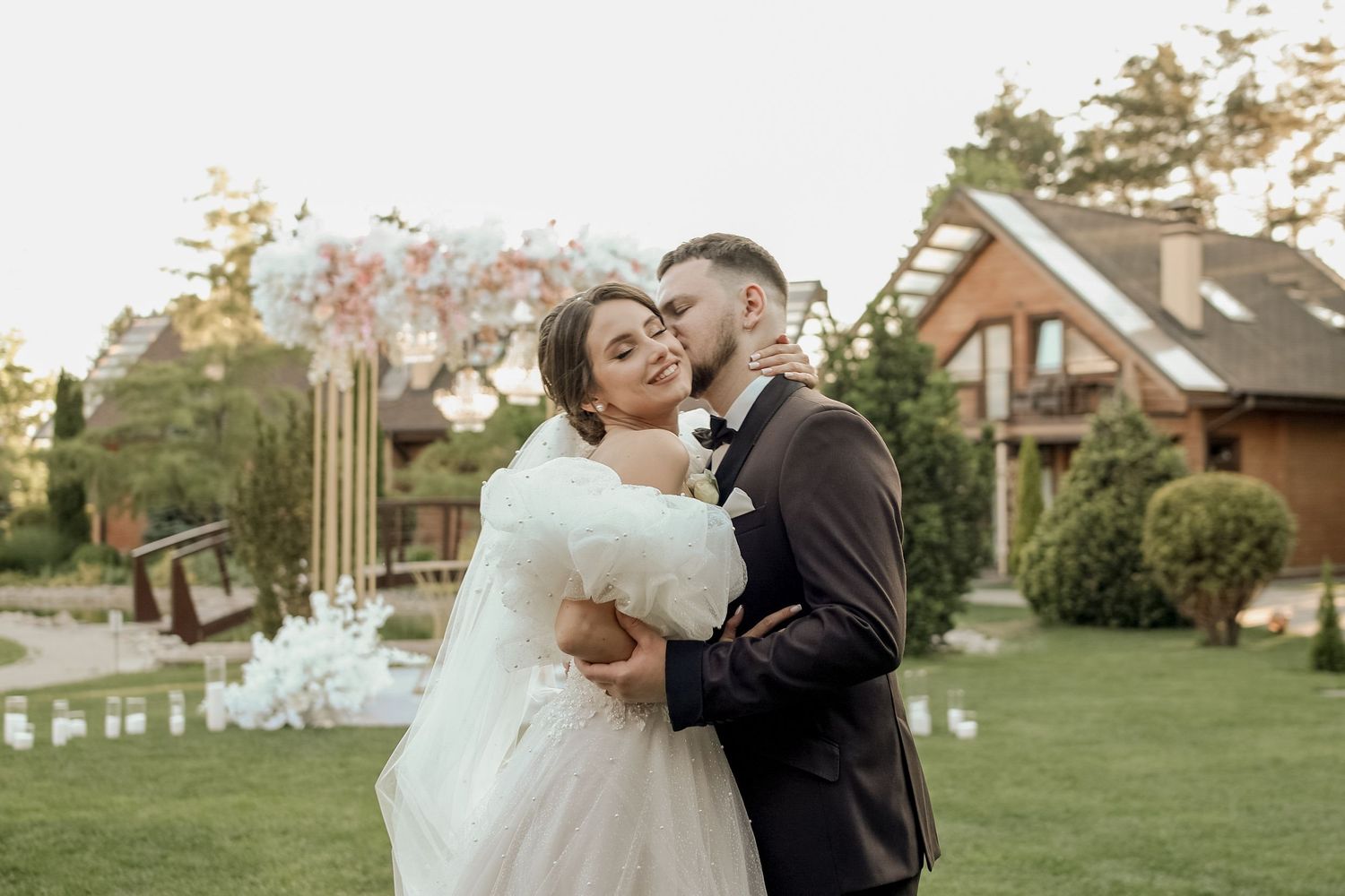 A couple shares romantic moments in their wedding attire across multiple outdoor settings during golden hour.