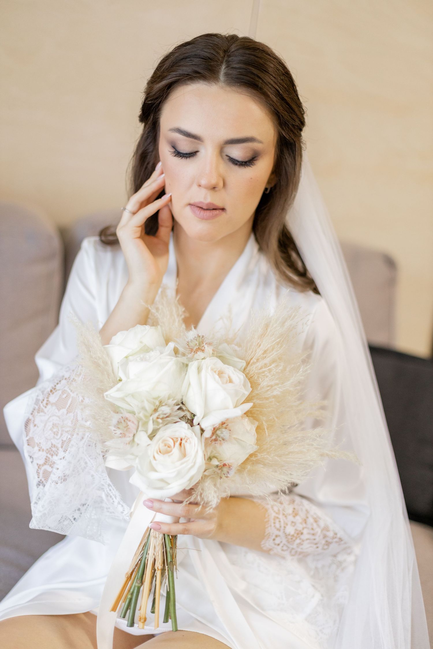 Romantic bridal portrait series featuring a bouquet of white roses and pampas grass.