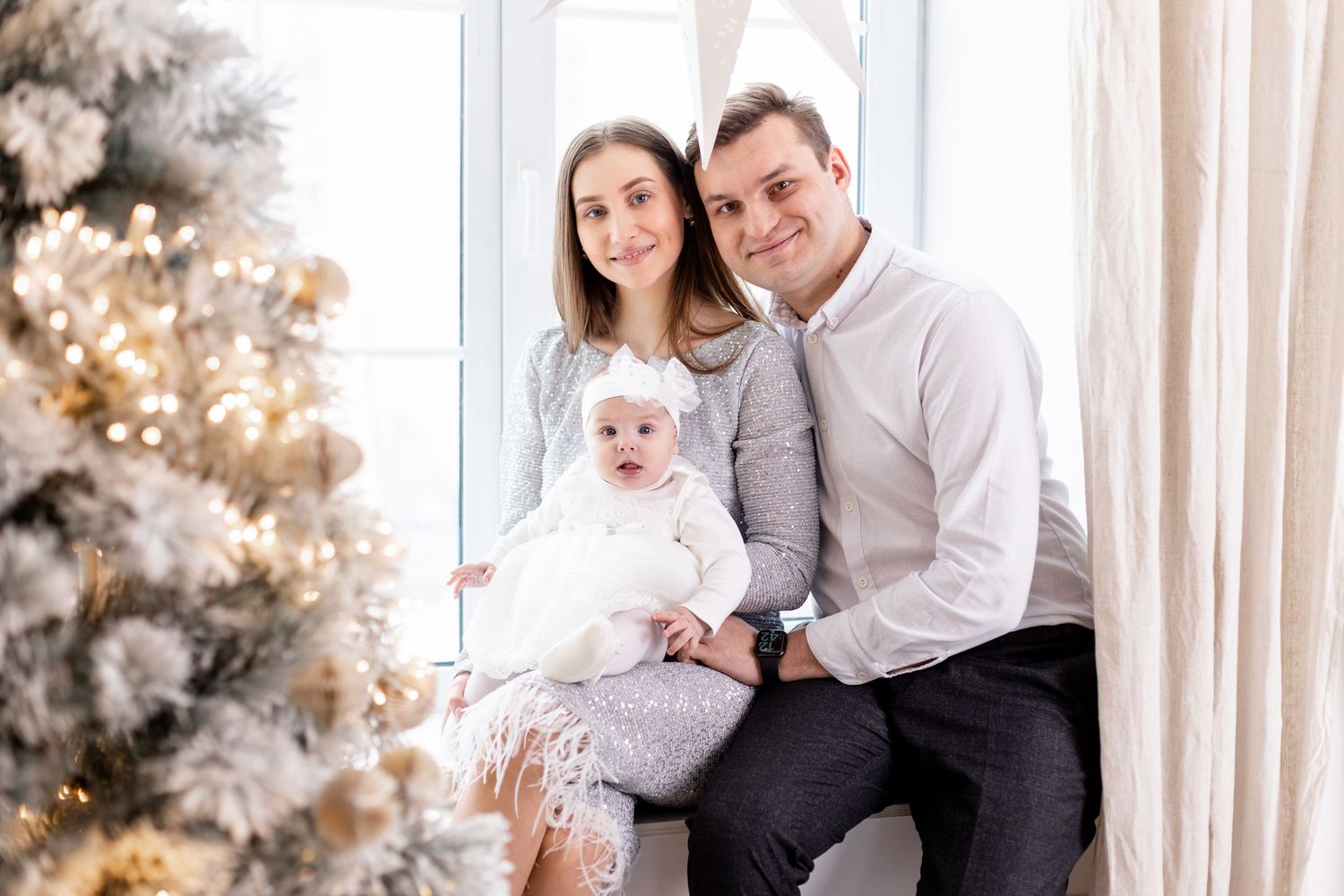 Tender family moment captured during winter holiday photoshoot with festive decorations.