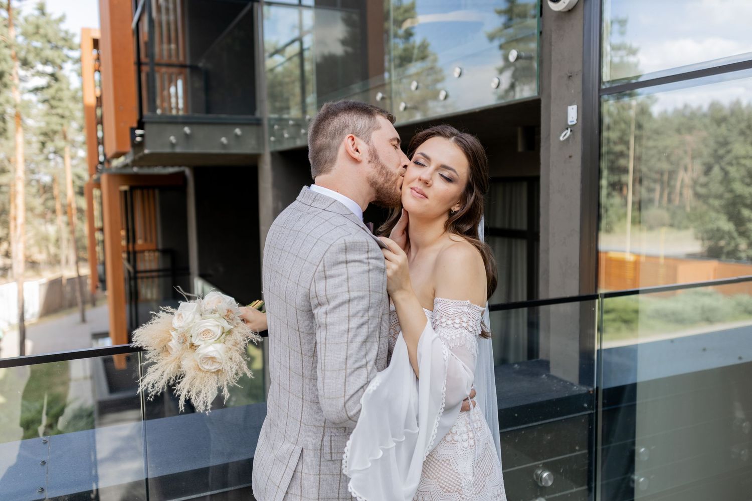 Intimate wedding portraits captured on a modern terrace with natural lighting.