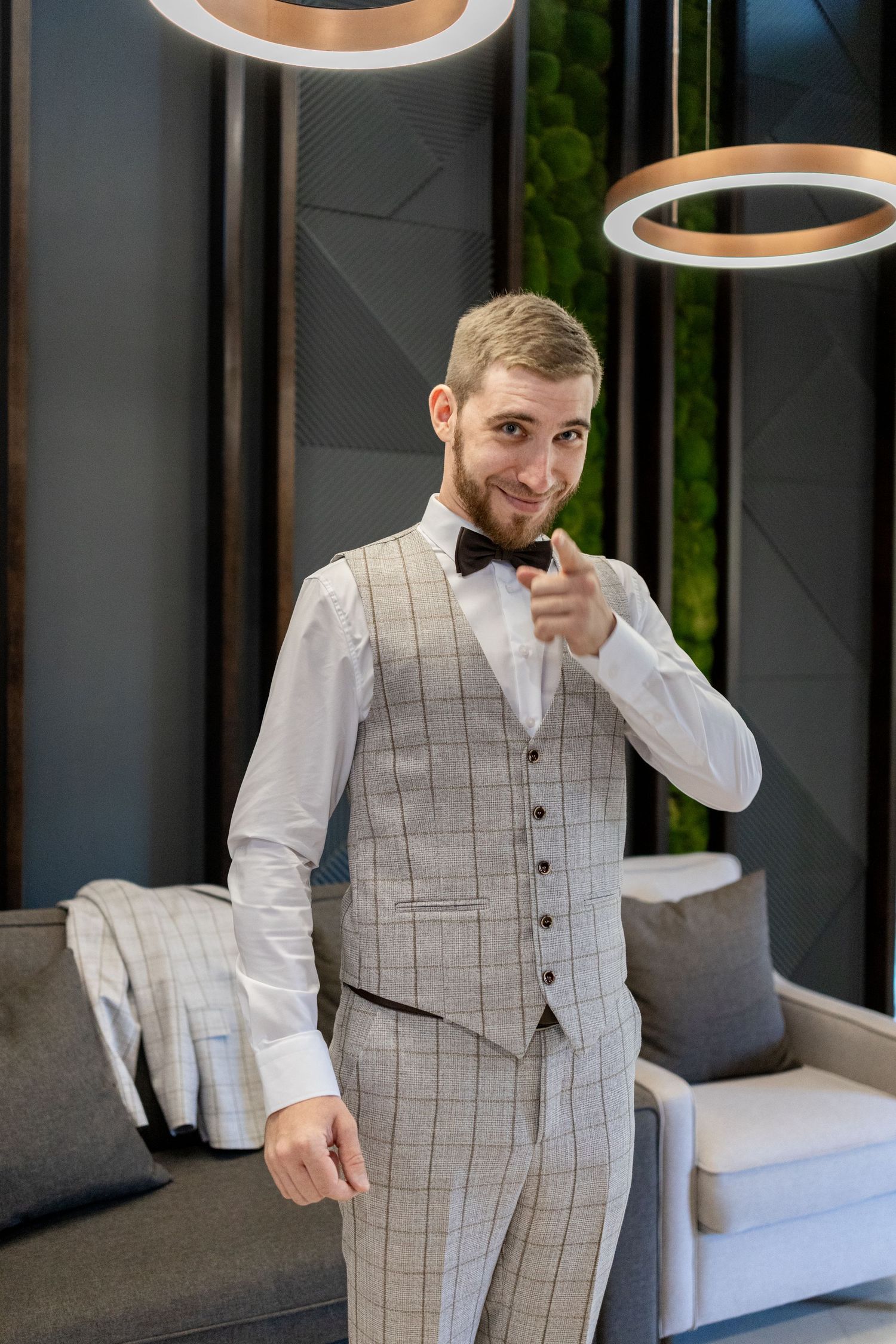 Modern gray plaid suit ensemble shown in multiple poses against dark interior backdrop.