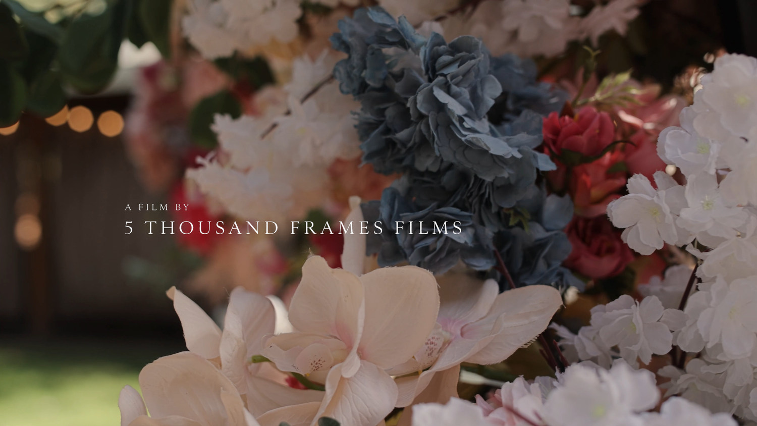 A cinematic floral arrangement featuring blue hydrangeas and pink blossoms with 5 Thousand Frames Films title overlay.