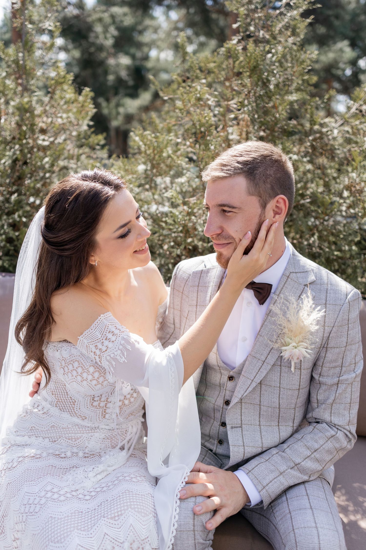 A series of intimate moments between a couple in wedding attire on an outdoor bench.