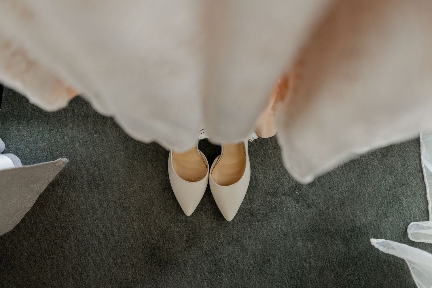 Elegant nude heels arranged with flowing white fabric.
