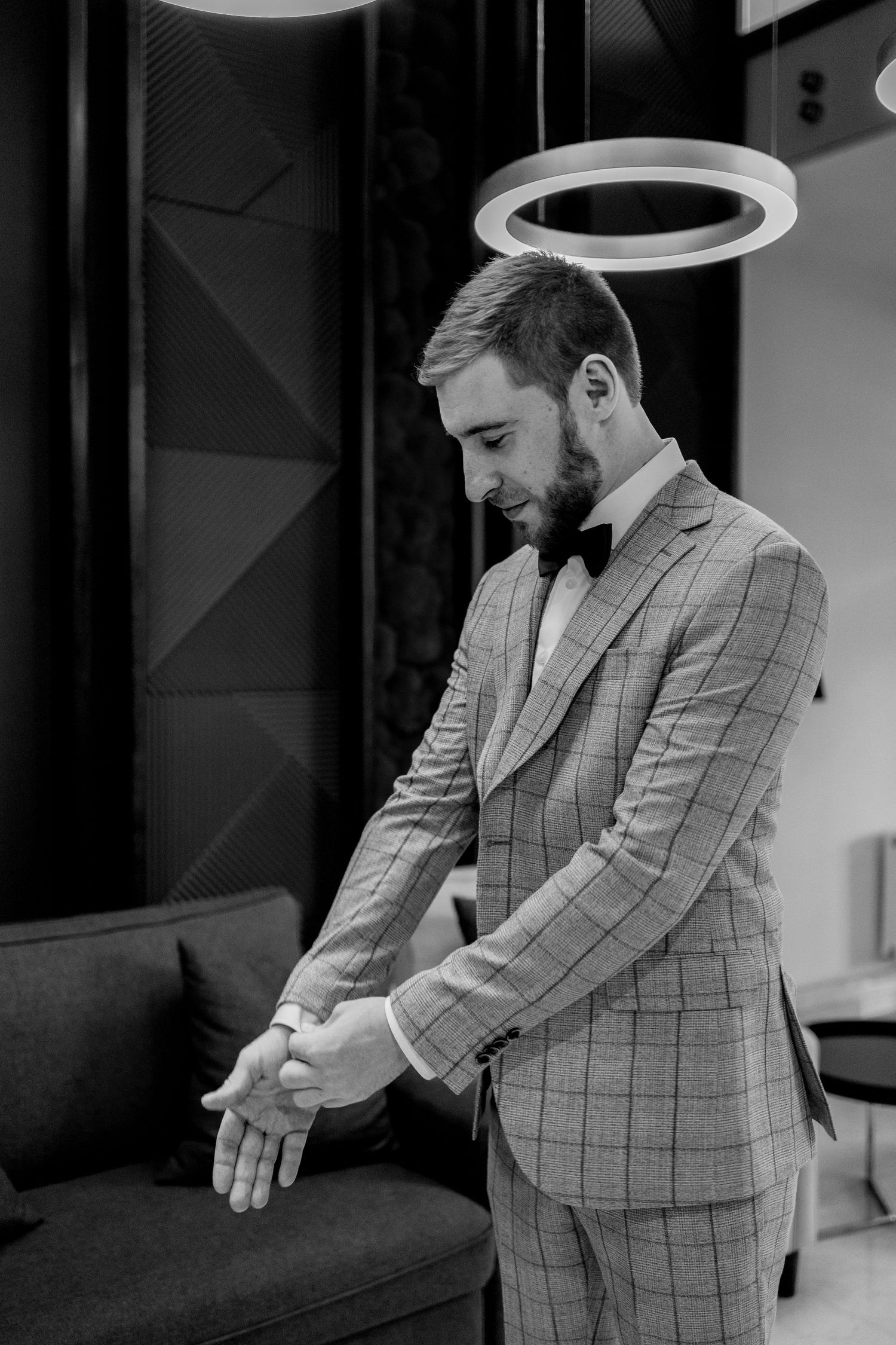 Black and white portraits showing movement in tailored gray plaid suit.