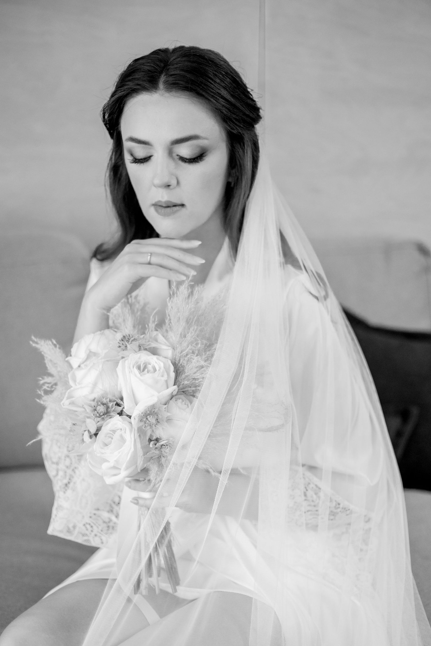Black and white photos of bridal preparations with delicate veil and floral details.