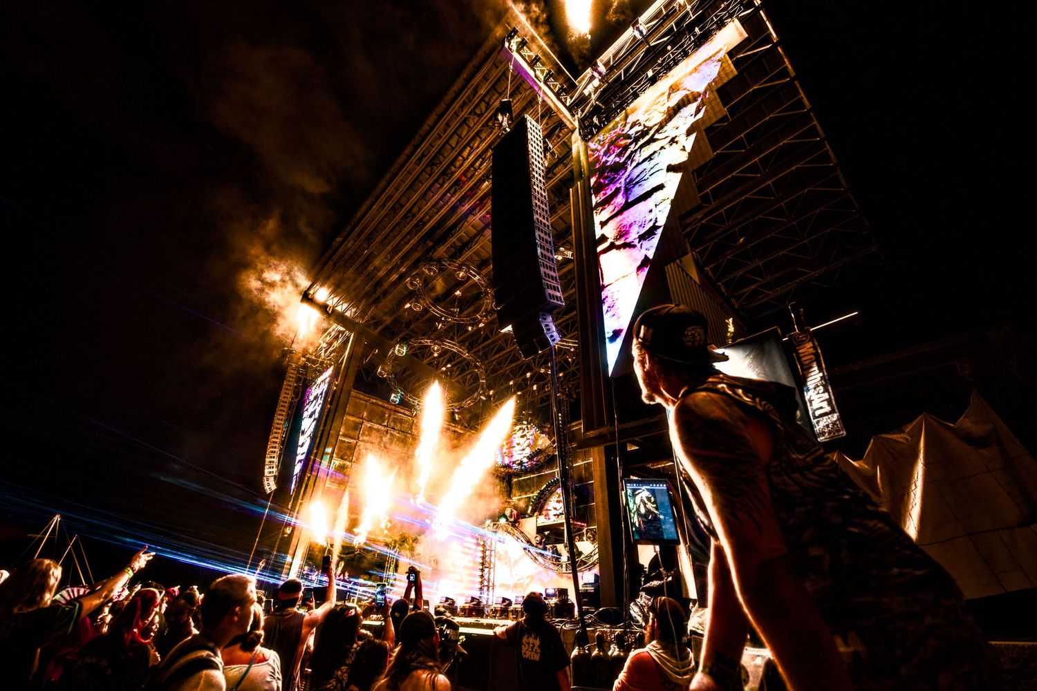 A sequence of firework explosions lighting up the dark night sky with bright golden sparks and colorful bursts.