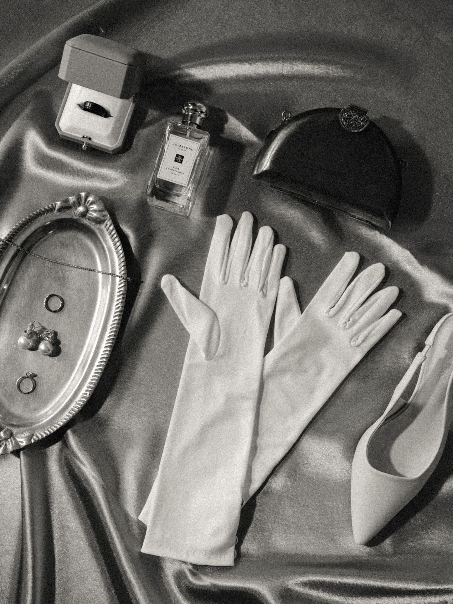 A series of black and white photographs showing white gloves arranged with computer mice and technology devices.