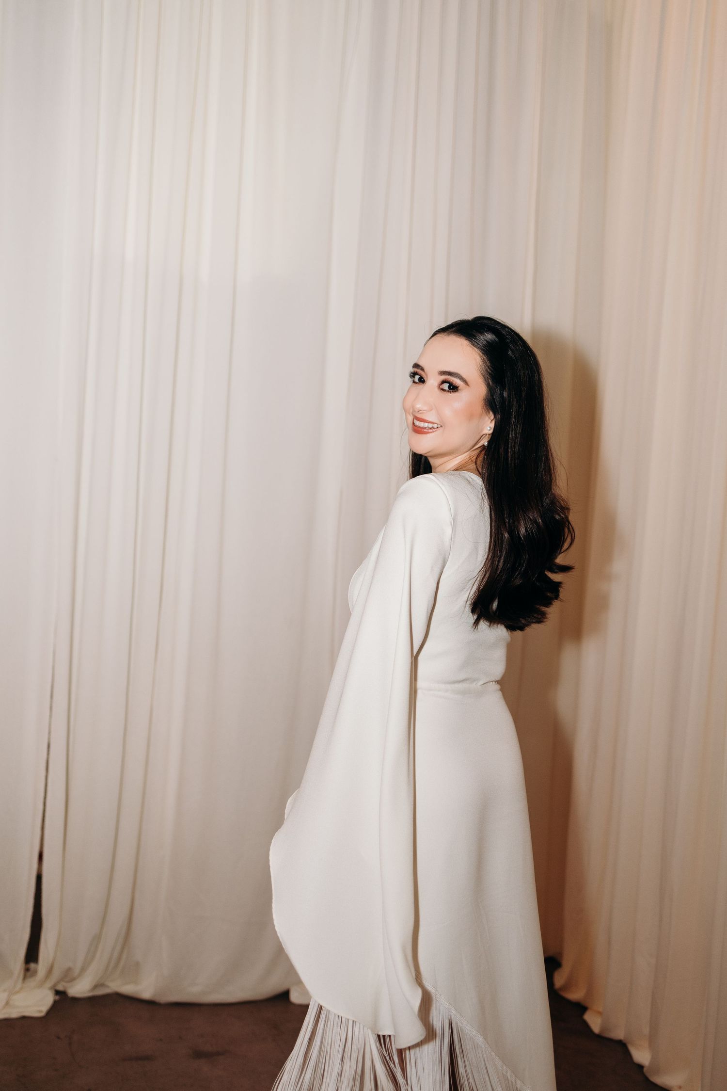 Fashion photo sequence showing movement of a white flowing sleeve against a light curtain backdrop.