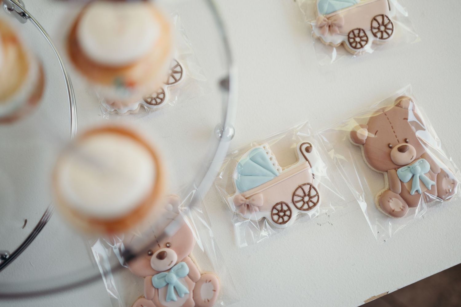 Decorative baby-themed cookies arranged on a white surface.