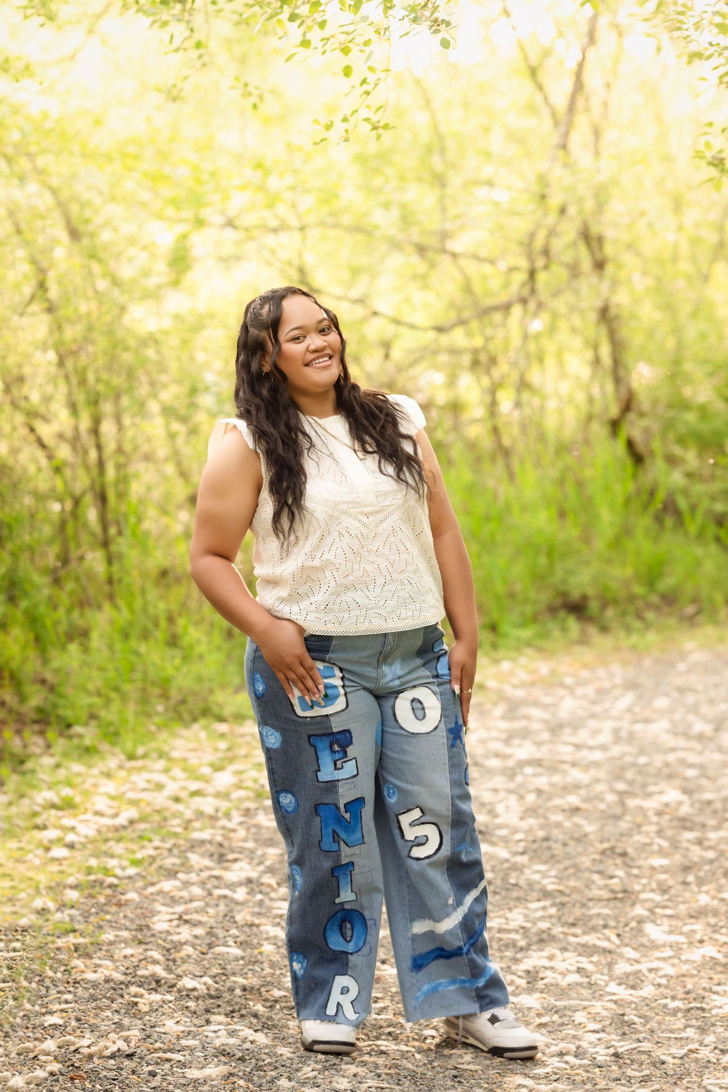 A series of weight loss progress photos showing oversized jeans being held up on a nature path with autumn foliage.