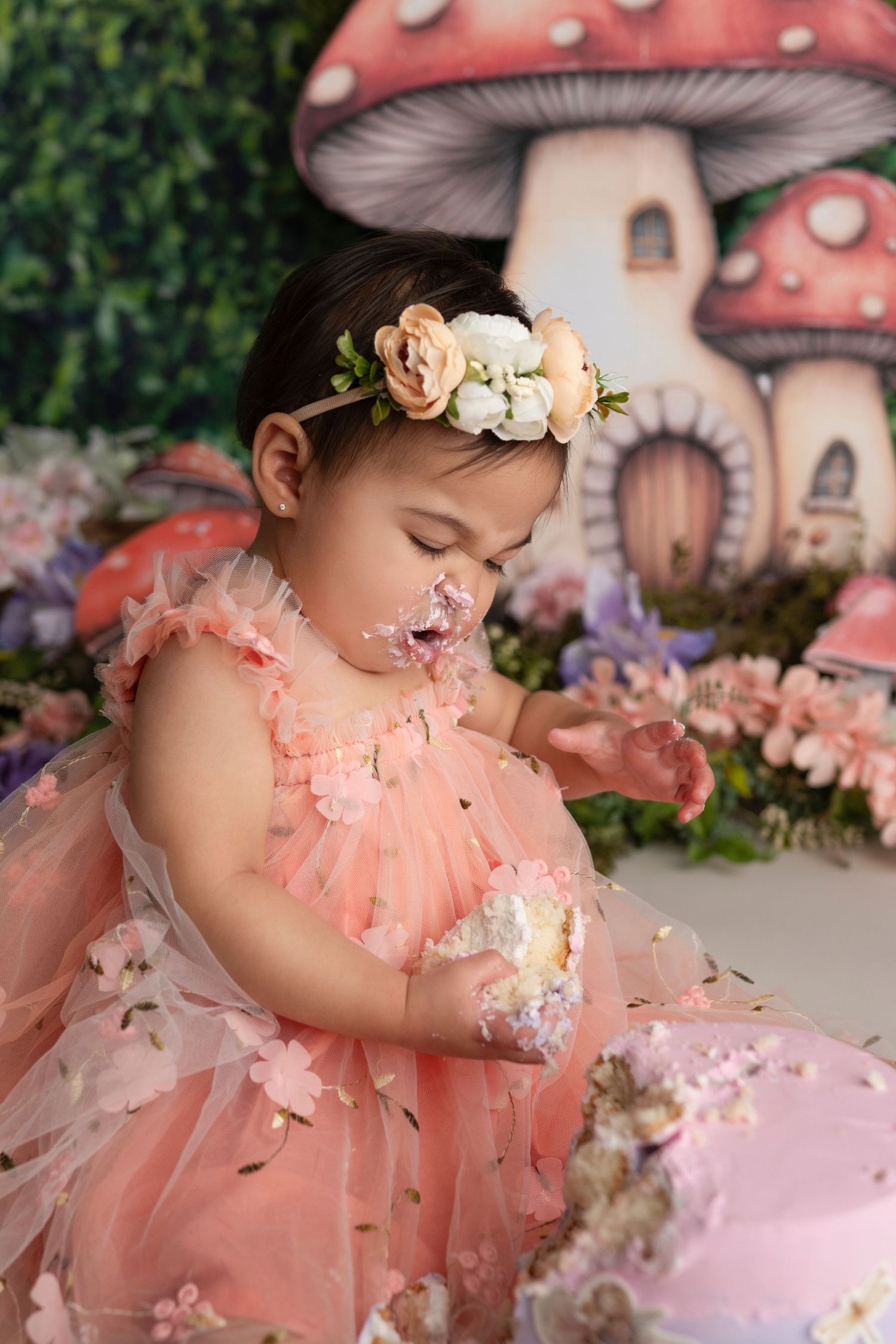 Whimsical fairy tale photo series with pink mushroom houses and dreamy peach tulle dress against magical forest backdrop.